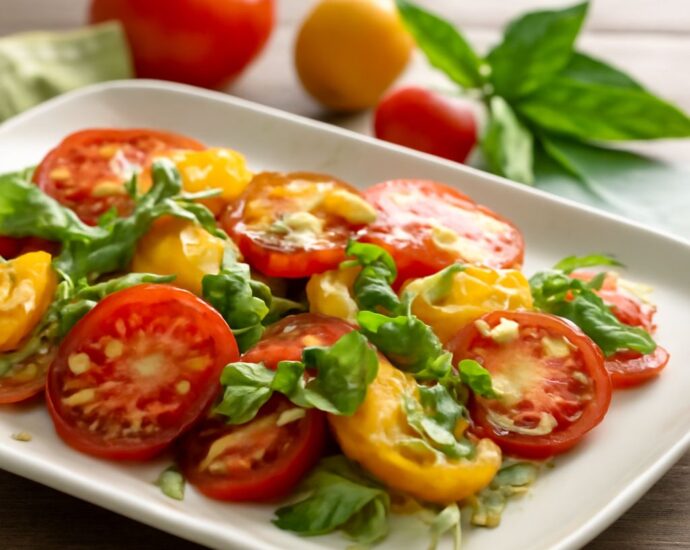 Colorful heirloom tomatoes with basil, toast, and roasted tomato slices