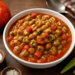 Sautéed okra with tomatoes, onion, and garlic in a skillet