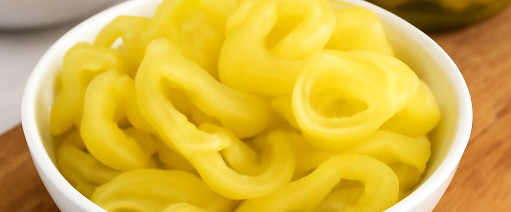 Pickled banana pepper recipes shown as crisp, tangy rings in a jar