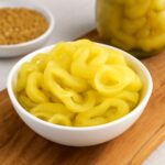 Pickled banana pepper recipes shown as crisp, tangy rings in a jar
