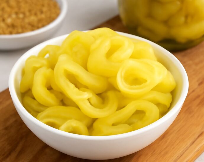 Pickled banana pepper recipes shown as crisp, tangy rings in a jar