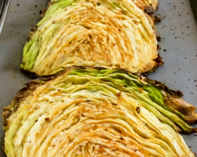 Browned and tender roasted cabbage wedges on a sheet pan