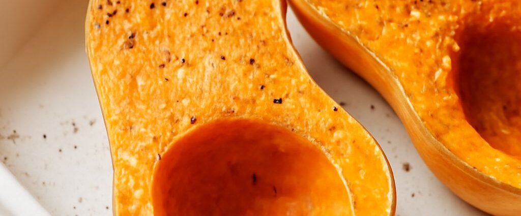 Caramelized butternut squash cubes on a sheet pan