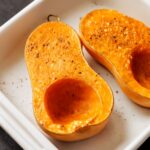 Caramelized butternut squash cubes on a sheet pan