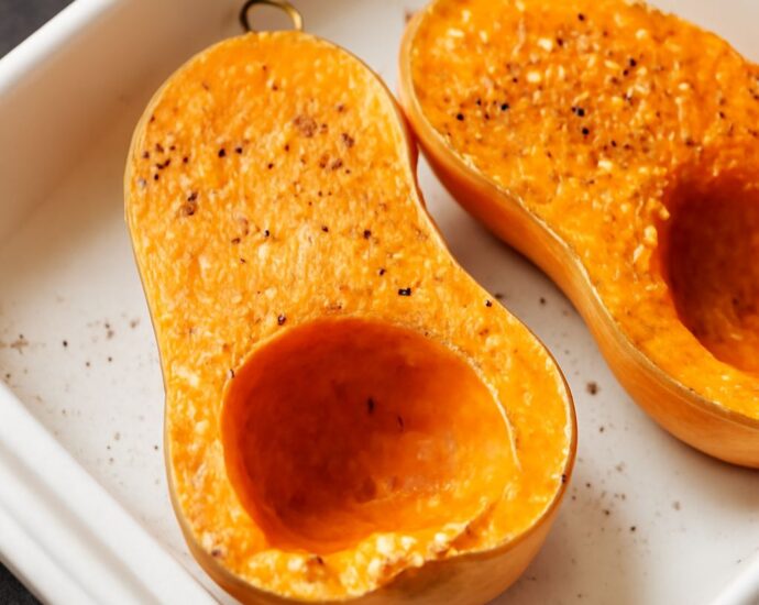 Caramelized butternut squash cubes on a sheet pan