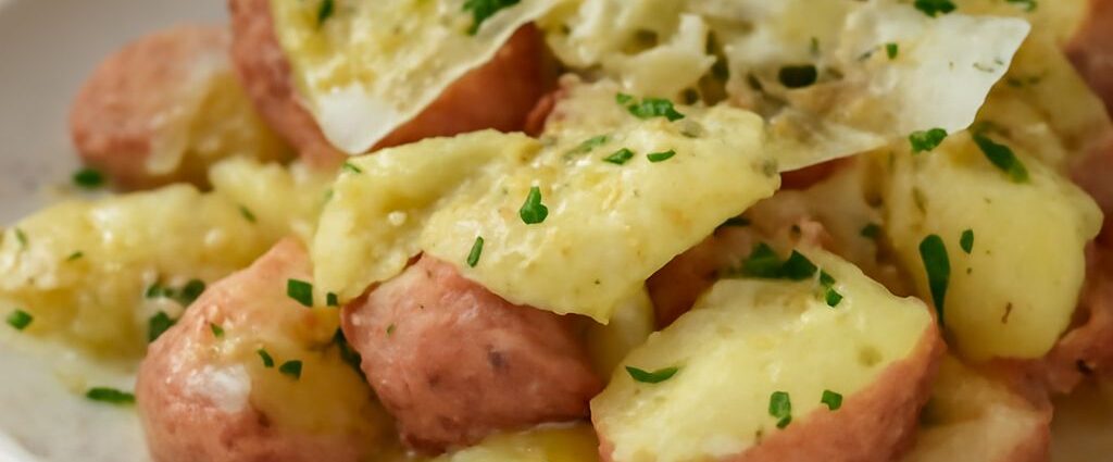 A tray of crisp-golden smashed red potatoes with creamy centers