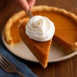 Southern-style sweet potato pie with a smooth golden filling on a white plate