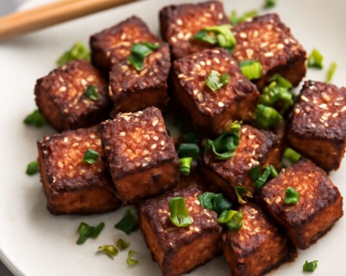 Packaged silken and firm tofu beside cooked tofu pieces
