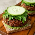 Vegan black bean burgers with browned edges and lettuce on toasted buns