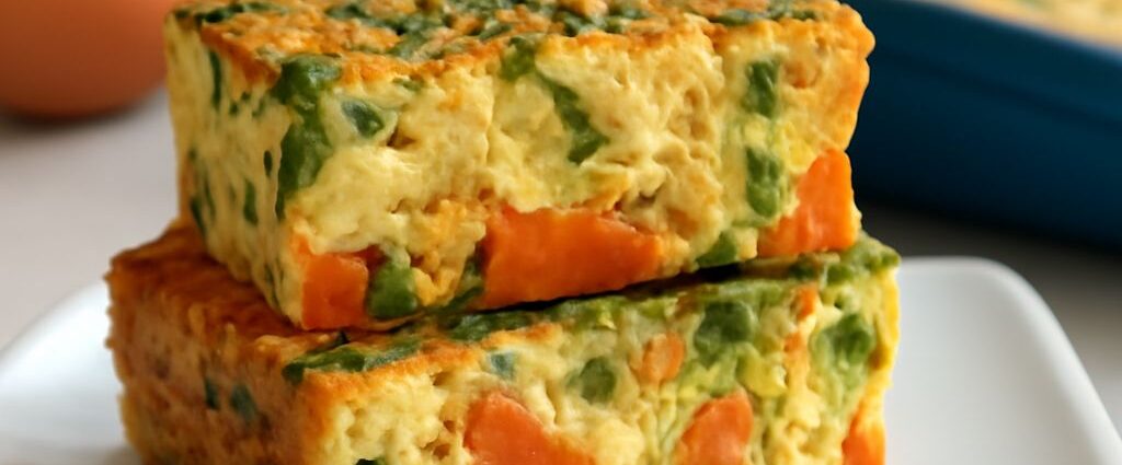Sliceable veggie egg bake with colorful vegetables in a square baking pan