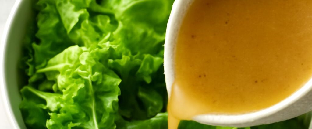 Tender-crisp lettuce salad with glossy leaves and warm sweet-tangy dressing