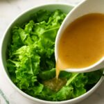 Tender-crisp lettuce salad with glossy leaves and warm sweet-tangy dressing