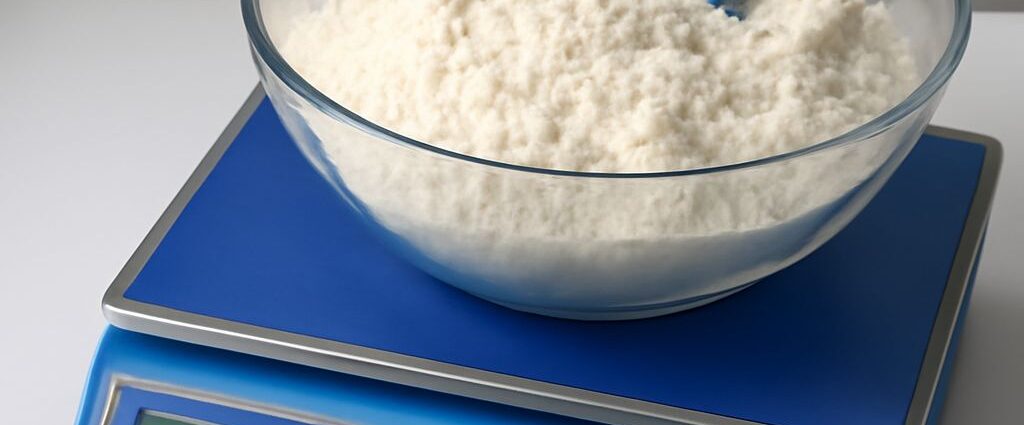 Measuring cup filled with flour on a scale