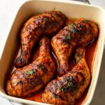 Chicken legs being baked in the oven