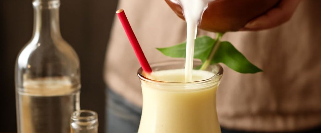 A refreshing homemade pina colada served in a glass with a pineapple slice garnish.