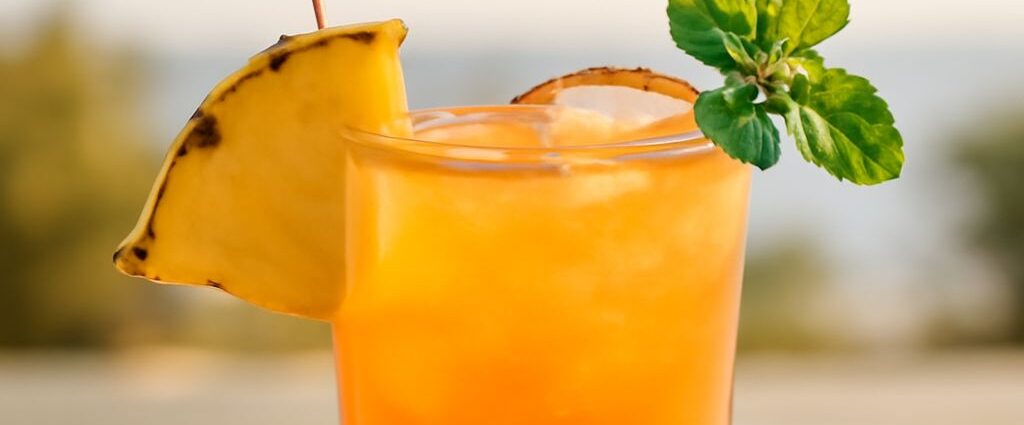 A classic Mai Tai cocktail garnished with lime and mint.