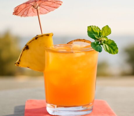 A classic Mai Tai cocktail garnished with lime and mint.