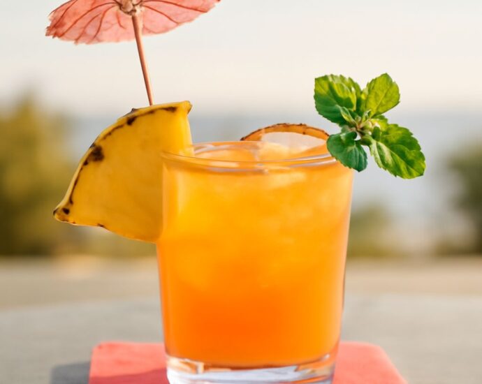 A classic Mai Tai cocktail garnished with lime and mint.
