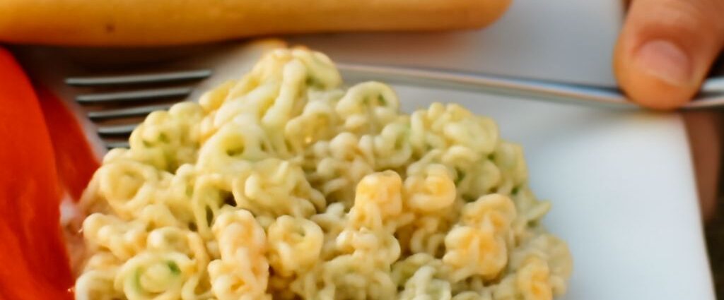 A bowl of old fashioned macaroni salad with ingredients.