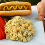 A bowl of old fashioned macaroni salad with ingredients.
