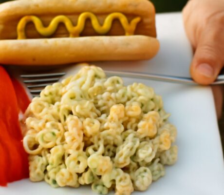 A bowl of old fashioned macaroni salad with ingredients.