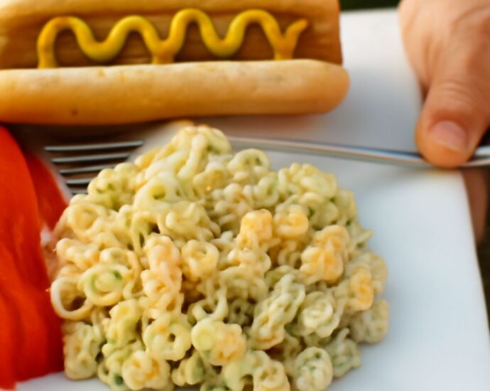 A bowl of old fashioned macaroni salad with ingredients.