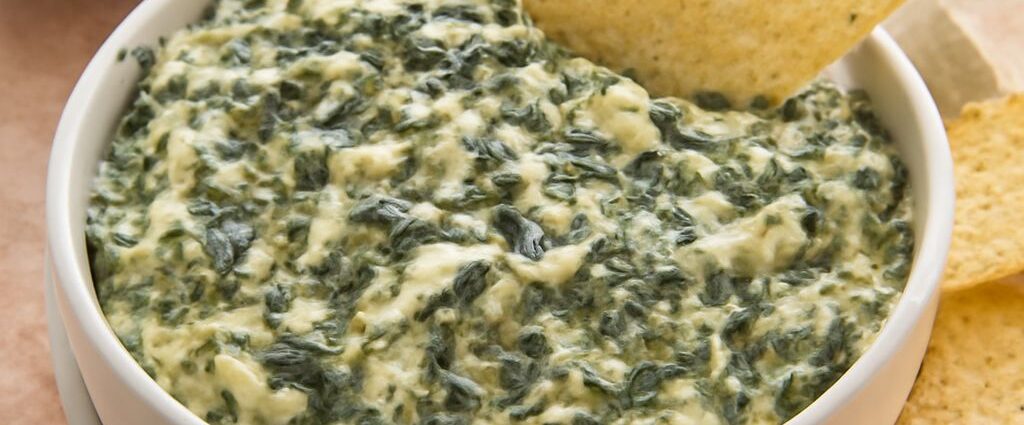 A delicious spinach artichoke dip in a serving bowl