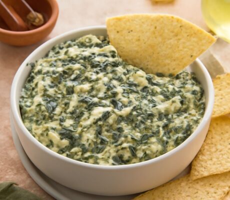 A delicious spinach artichoke dip in a serving bowl